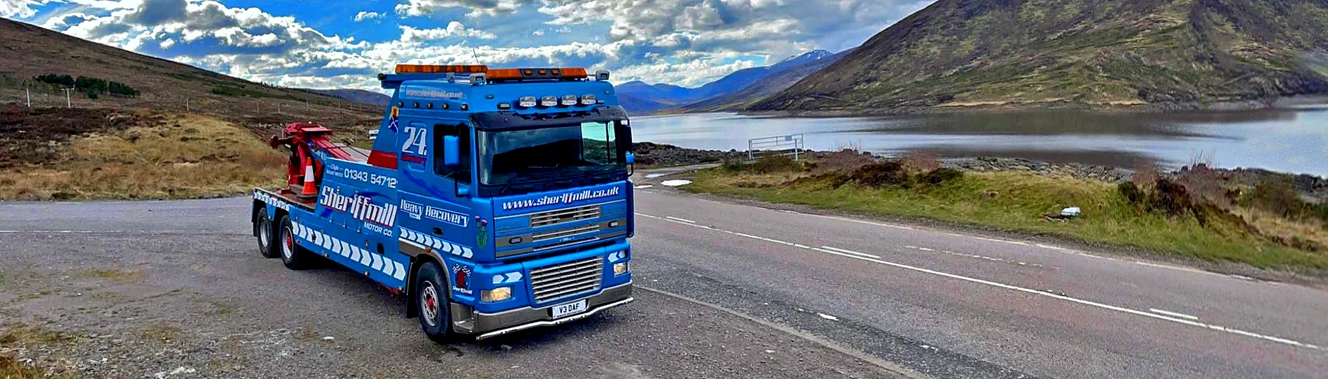 Sheriffmill recovery truck parked beside a Highland loch